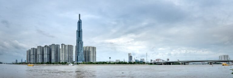 Panoramic view of Landmark 81 and modern skyline across the Saigon River in Ho Chi Minh City, Vietnam.