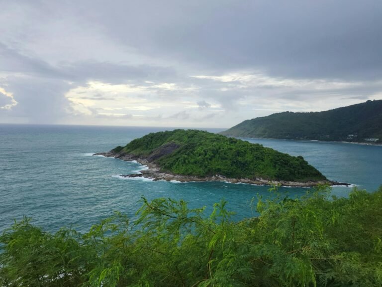 A serene view of Promthep Cape with lush greenery and turquoise waters in Phuket, Thailand.