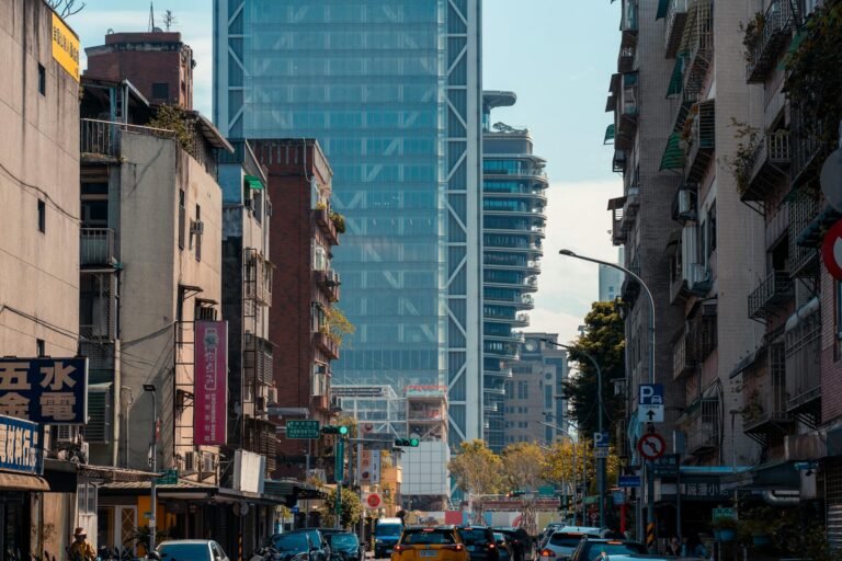 Dynamic city scene capturing a busy street lined with diverse architecture and modern skyscrapers.
