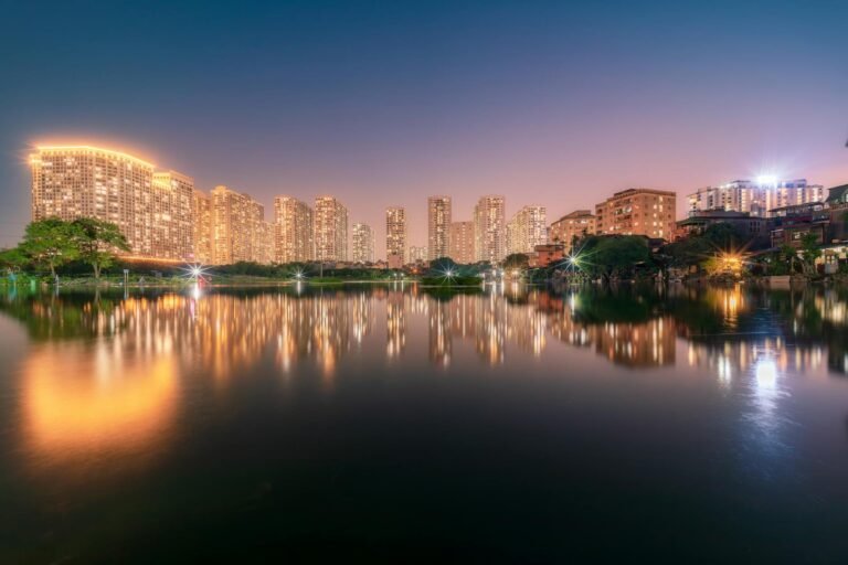 Stunning view of Hanoi's skyline reflecting on water during the night.