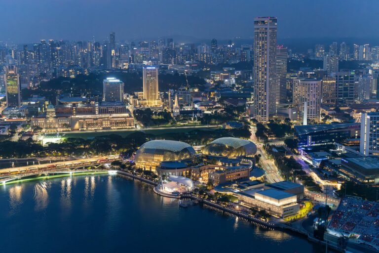 Captivating aerial view of Singapore's illuminated skyline and Marina Bay at night.