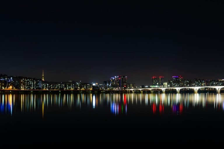 Stunning night view of Seoul's illuminated skyline reflected over the Han River.