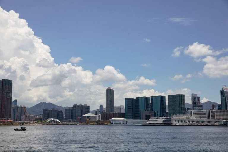 Beautiful Hong Kong skyline featuring Victoria Harbour under a clear blue sky.