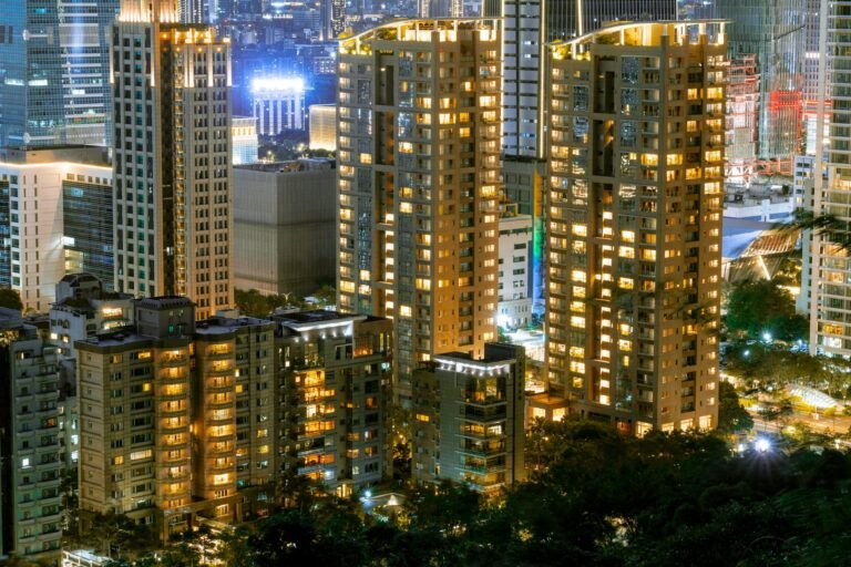 Stunning cityscape at night featuring illuminated skyscrapers and urban lights.
