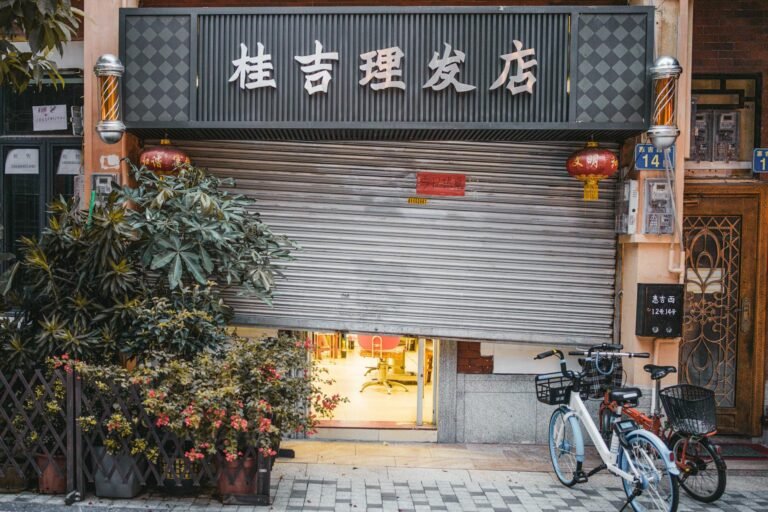 A cozy barbershop with bicycles outside in a bustling street of Guangzhou, China.