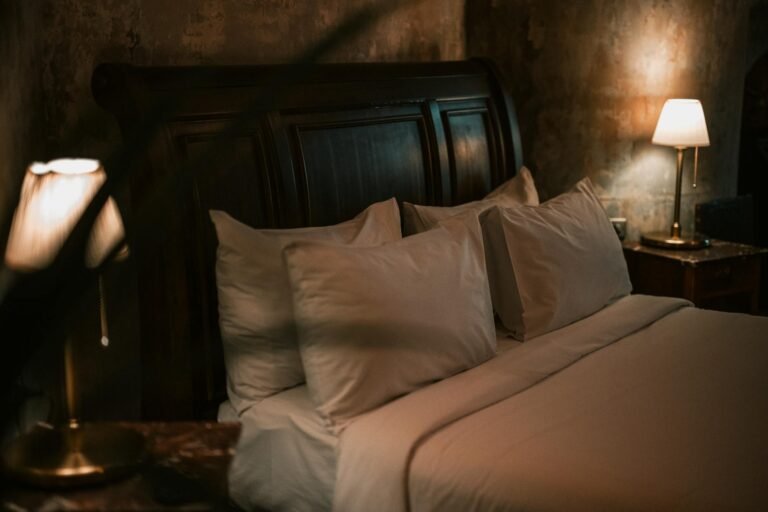 A cozy bedroom setup featuring soft lighting and a comfortable bed, creating a warm ambiance.