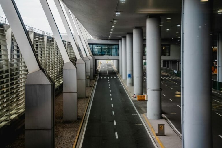 Explore the sleek design of a terminal at Shanghai Airport with towering pillars and modern architecture.