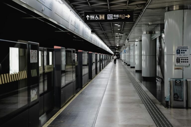 Wide view of a deserted platform in a Shanghai Metro station, showcasing modern architecture.