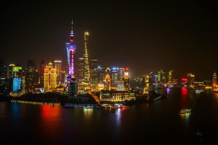A breathtaking aerial night view of the illuminated Shanghai skyline along the Huangpu River.