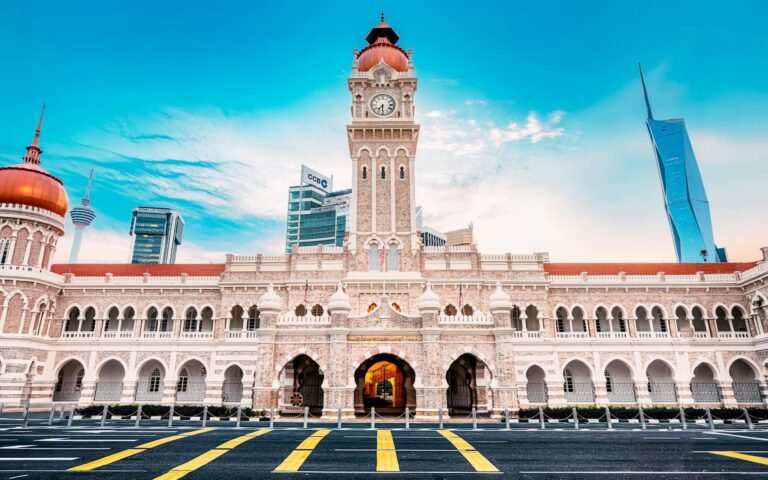 The iconic Sultan Abdul Samad Building against a clear sky in Kuala Lumpur, Malaysia.