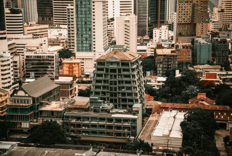 Aerial view showcasing the diverse architecture of Bangkok, Thailand's skyline with modern and classic buildings.