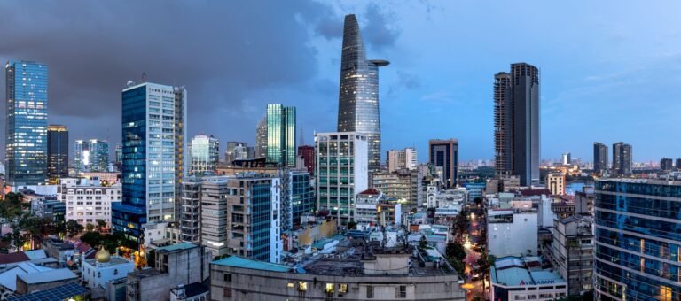 Panoramic view of Ho Chi Minh City skyline with iconic skyscrapers, captured at dusk.