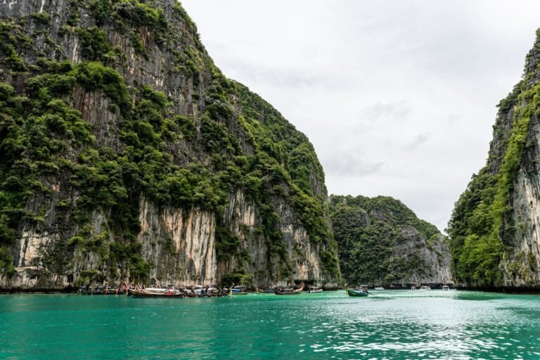 Explore the breathtaking limestone cliffs and turquoise waters of Phuket, Thailand, in this serene landscape.
