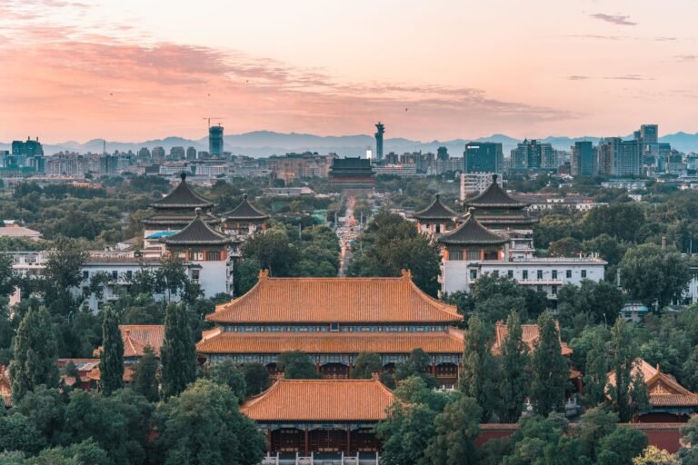 A beautiful cityscape of Beijing featuring historic temples at sunset, capturing the mix of tradition and modernity.