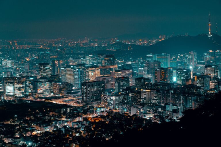 A breathtaking view of a brightly lit city skyline at night, showcasing urban life.