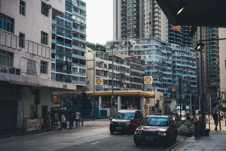 Vibrant street scene in a metropolitan area featuring modern buildings and bustling traffic.