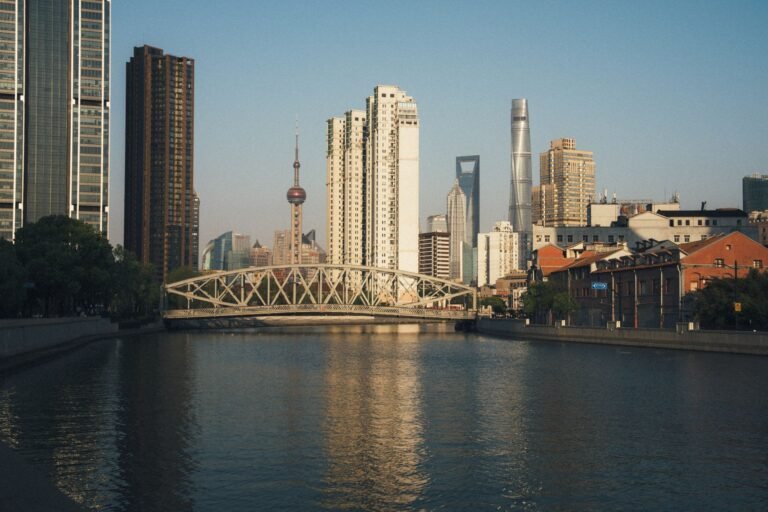 Stunning view of Shanghai's skyline featuring famous landmarks and Waibaidu Bridge during sunset.