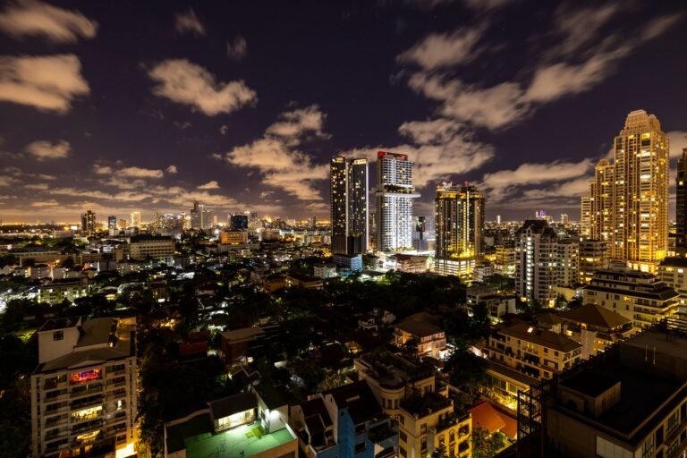 Mesmerizing view of Bangkok's illuminated skyline at night, showcasing modern skyscrapers.