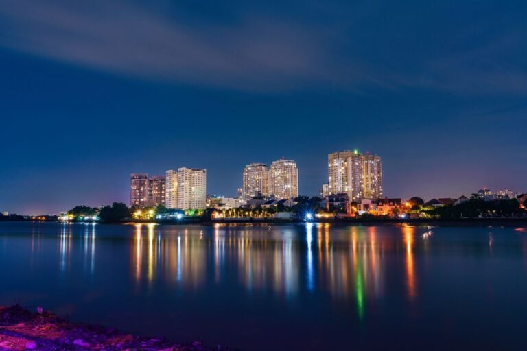 Stunning long exposure of Ho Chi Minh City skyline reflecting on water at night.